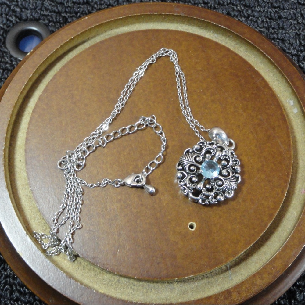 Bali inspired pendant with blue topaz, stone and chain, metal alloy.